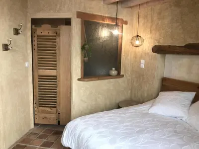 Un ou plusieurs lits dans un hébergement de l'établissement Chambre Les Marguerites