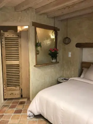 Un ou plusieurs lits dans un hébergement de l'établissement Chambre Les Marguerites