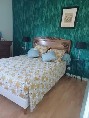 Un ou plusieurs lits dans un hébergement de l'établissement Chambre calme et agréable