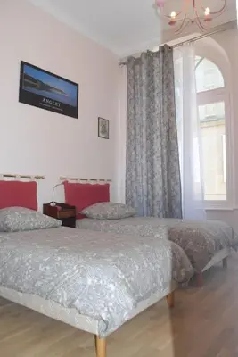Un ou plusieurs lits dans un hébergement de l'établissement Grand Appartement a Maison sculptée