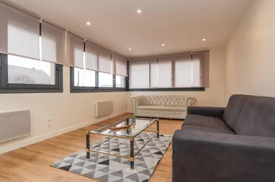 Coin salon dans l'établissement Le Pied à Terre de Montcenis - Appt avec parking privé