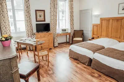 Un ou plusieurs lits dans un hébergement de l'établissement Appart Hotel Charles Sander