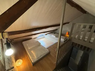 Un ou plusieurs lits dans un hébergement de l'établissement La Maison du bonheur - Gîte RULINA - Corancy