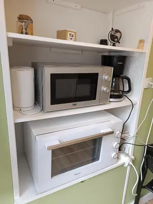 Cuisine ou kitchenette dans l'établissement Studio vert tout équipé wifi