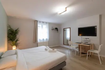 Un ou plusieurs lits dans un hébergement de l'établissement Appart'Hotel Tournusien