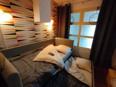 Un ou plusieurs lits dans un hébergement de l'établissement Appartement plein centre avec terrasse