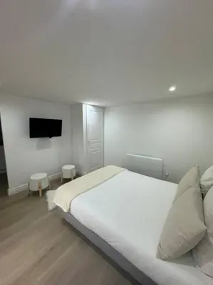 Un ou plusieurs lits dans un hébergement de l'établissement Bel appartement rez-de-chaussée