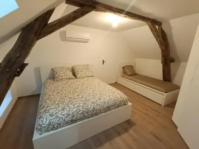 Un ou plusieurs lits dans un hébergement de l'établissement Maison cosy à Touillon