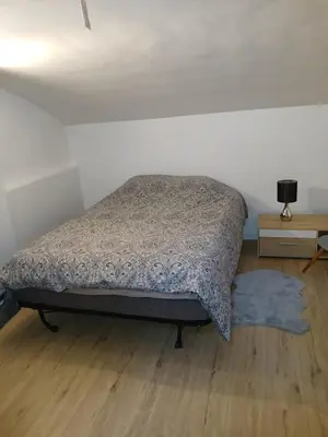 Un ou plusieurs lits dans un hébergement de l'établissement Appartement plein pied