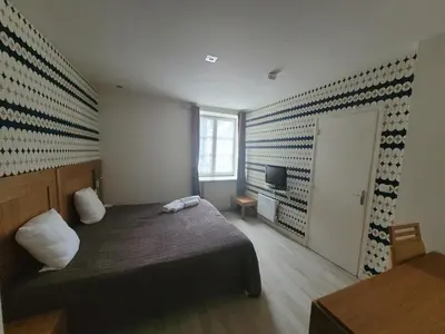 Un ou plusieurs lits dans un hébergement de l'établissement Hôtel de L'Ecu