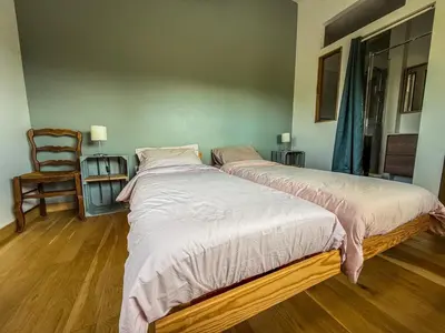 Un ou plusieurs lits dans un hébergement de l'établissement Gîte Domaine Taureau
