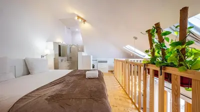 Un ou plusieurs lits dans un hébergement de l'établissement La Maisonnette - Hypercentre - Movie Theater