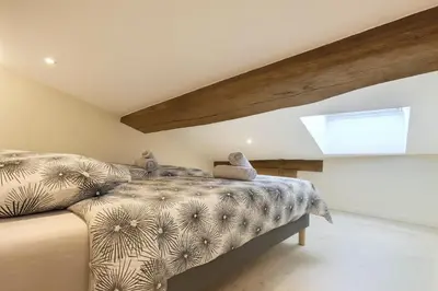 Un ou plusieurs lits dans un hébergement de l'établissement L Oasis Mâconnaise d Excellence Conciergerie