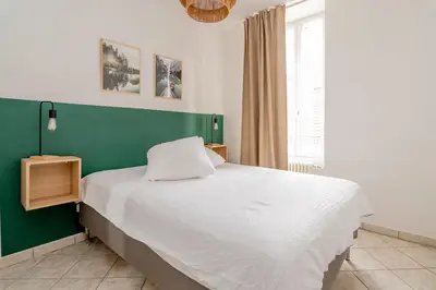 Un ou plusieurs lits dans un hébergement de l'établissement Appartement proche gare