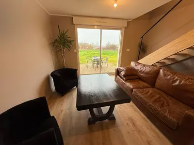 Coin salon dans l'établissement Maison neuve proche Dole - Forêt de Chaux