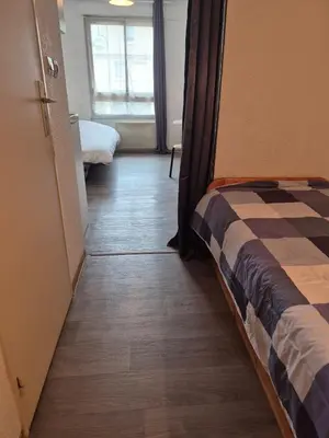 Un ou plusieurs lits dans un hébergement de l'établissement Studio meublé centre ville Paray 1B07