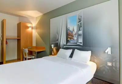 Un ou plusieurs lits dans un hébergement de l'établissement B&B HOTEL Beaune Sud 2