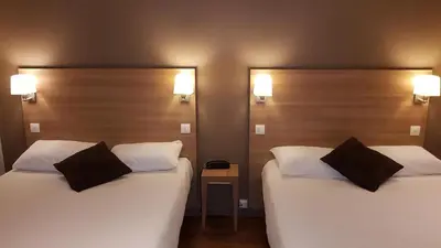 Un ou plusieurs lits dans un hébergement de l'établissement Hôtel Montchapet Dijon Centre