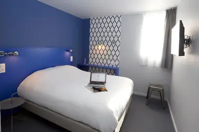 Un ou plusieurs lits dans un hébergement de l'établissement Coto Hotel