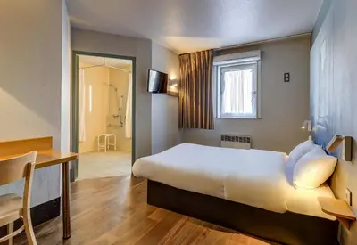 Un ou plusieurs lits dans un hébergement de l'établissement B&B HOTEL Dijon Nord Zénith