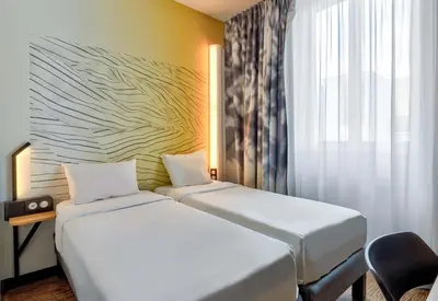 Un ou plusieurs lits dans un hébergement de l'établissement B&B HOTEL Dijon Centre