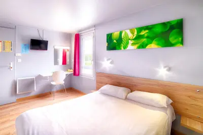 Un ou plusieurs lits dans un hébergement de l'établissement Brit Hotel Macon Nord Autoroute du Soleil