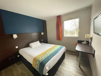 Un ou plusieurs lits dans un hébergement de l'établissement Hôtel Restaurant Kyriad Direct DIJON NORD - Zenith - Toison d'Or