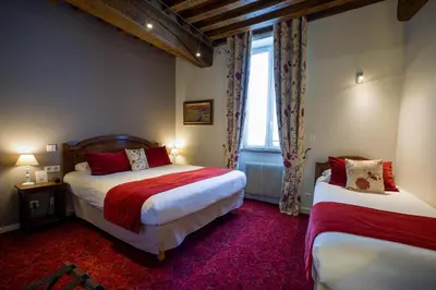 Un ou plusieurs lits dans un hébergement de l'établissement Teritoria Hôtel Wilson