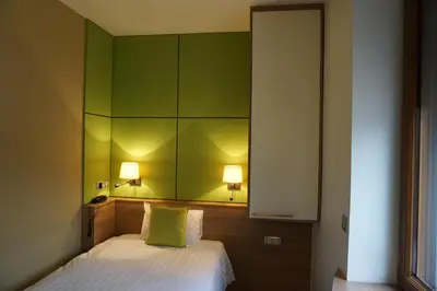 Un ou plusieurs lits dans un hébergement de l'établissement Hôtel Restaurant Du Parc de la Colombière