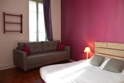 Un ou plusieurs lits dans un hébergement de l'établissement Hôtel de la Colombière