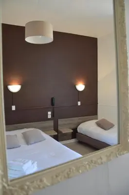 Un ou plusieurs lits dans un hébergement de l'établissement Hôtel de la Colombière