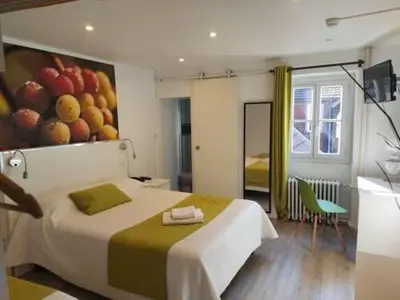 Un ou plusieurs lits dans un hébergement de l'établissement Hôtel Le Chambellan