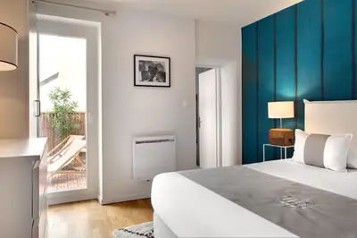 Un ou plusieurs lits dans un hébergement de l'établissement Appartements des Ducs