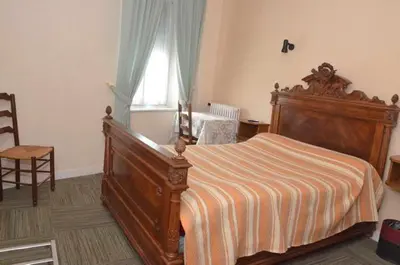 Un ou plusieurs lits dans un hébergement de l'établissement Hotel du Commerce