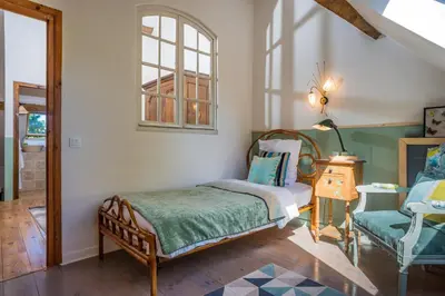 Un ou plusieurs lits dans un hébergement de l'établissement Maison le Village - Maison d’Hôtes