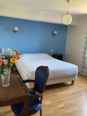 Un ou plusieurs lits dans un hébergement de l'établissement Hostellerie du Vieux Moulin