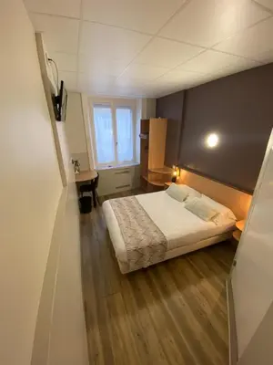 Un ou plusieurs lits dans un hébergement de l'établissement Nouvel Hotel