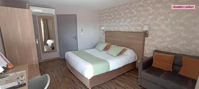 Un ou plusieurs lits dans un hébergement de l'établissement Hôtel Le Clos Badan