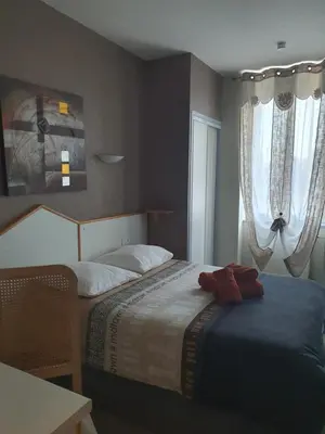 Un ou plusieurs lits dans un hébergement de l'établissement Hotel du Centre