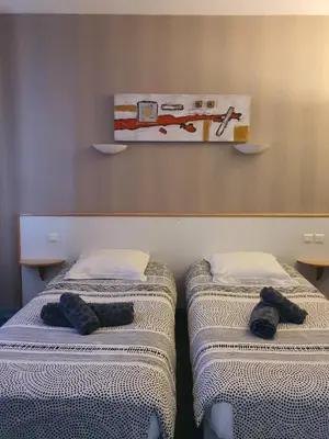 Un ou plusieurs lits dans un hébergement de l'établissement Hotel du Centre