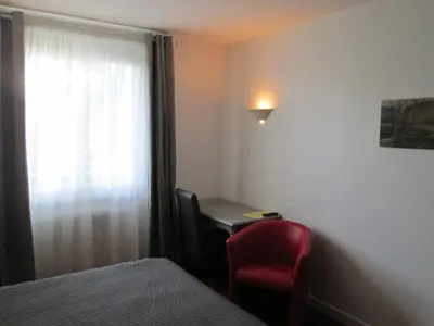 Un ou plusieurs lits dans un hébergement de l'établissement Hotel Victor Hugo