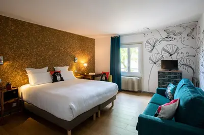 Un ou plusieurs lits dans un hébergement de l'établissement Hôtel Restaurant Gastronomique La Huchette