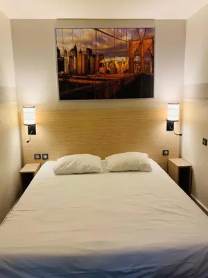 Un ou plusieurs lits dans un hébergement de l'établissement Hôtel Inn Design Dijon Sud