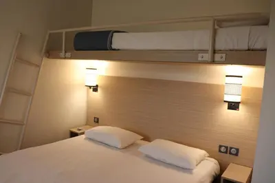 Un ou plusieurs lits dans un hébergement de l'établissement Hôtel Inn Design Dijon Sud