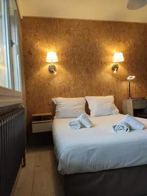 Un ou plusieurs lits dans un hébergement de l'établissement BAR HOTEL DU CENTRE (BDC)