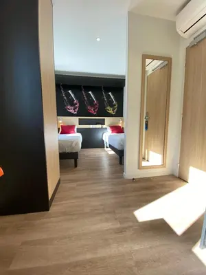 Un ou plusieurs lits dans un hébergement de l'établissement Appart Hotel Montchapet Dijon Centre