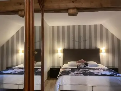 Un ou plusieurs lits dans un hébergement de l'établissement Gîte Le Domaine d Orphée