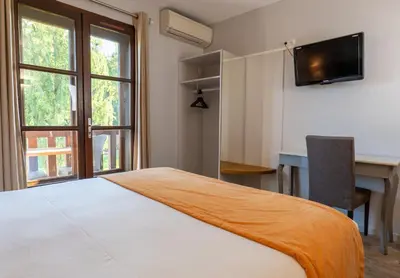 Un ou plusieurs lits dans un hébergement de l'établissement Hotel Village Motel