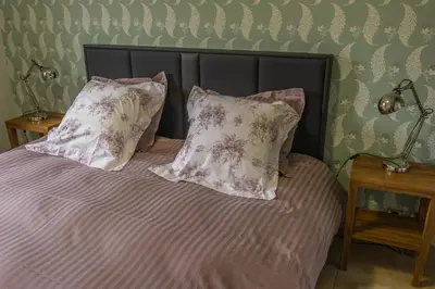 Un ou plusieurs lits dans un hébergement de l'établissement L'Appartement