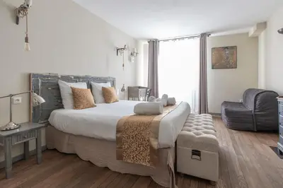 Un ou plusieurs lits dans un hébergement de l'établissement La Chouette des Ducs, Appartement en Hypercentre